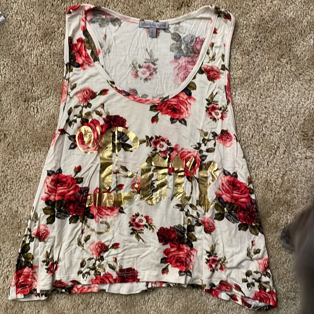 This is a shirt with roses on it. There is also the word Love on it in gold.